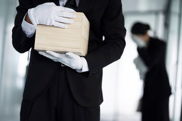 Bereaved holding urn at funeral