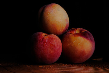 Fototapeta na wymiar Peaches on a black background
