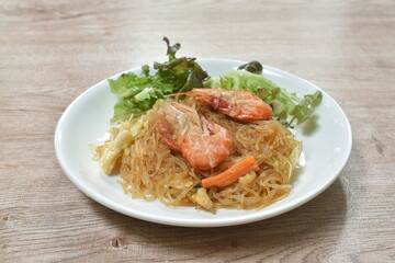 fried glass noodles with shrimp and cabbage with egg on plate