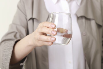 Close up of woman holding glass of water