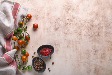 Fresh cherry tomato branches, napkin, red and black pepper on white marble stand background. Food cooking background and mock up.