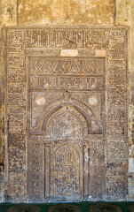 Ornate engraved stone wall with floral patterns and calligraphy at Tulunid era Ibn Tulun Mosque,...