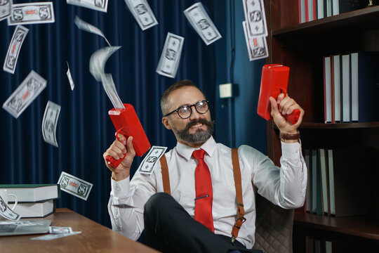 happy bearded business man play money gun shooting banknote