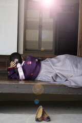 Woman in Korean traditional clothes lying on floor	