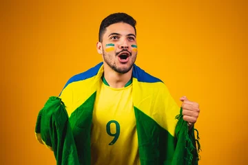Fotobehang brazilian fan cheering in the crowd on yellow background. © StockImageBrasil