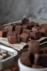 Chocolate brownie cake, dessert with milk on a dark background on a wooden table.
