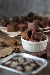 Chocolate brownie cake, dessert with milk on a dark background on a wooden table.