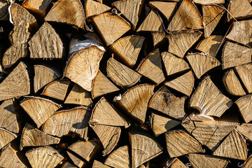 Fototapeta premium Chopped firewood stacked in a pile