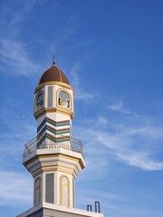 Mosque tower in the sky with clouds