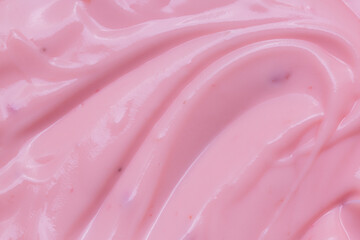 Obraz premium Macro Yogurt,Strawberry frozen yogurt background close up. Strawberry ice cream texture close up. Top view. Pink fruit ice cream background with small pieces of berries