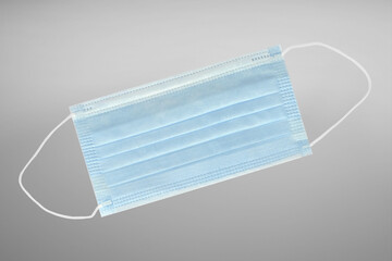 Medical mask on gray background