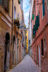 Old narrow streets or calles of Venice, Italy. Medieval atmosphere, shabby and empty alleyways, UNESCO World heritage city.
