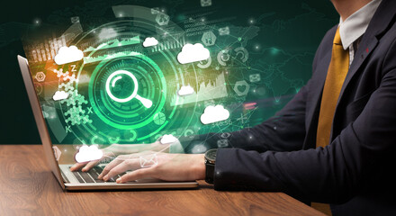 Business hand typing on a modern laptop