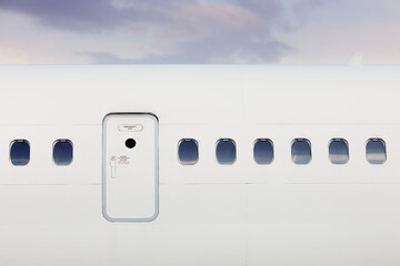 Fuselage of airplane with door and windows. Plane against moody sky. - Powered by Adobe