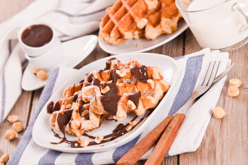 Waffles with chocolate cream and hazelnuts.