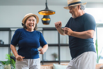 asian senior happiness couple home isolation concept,asian old retired adult couple dancing together at living room with cheerful and joyful moment ,Lovely senior couple dancing at home