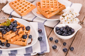 Waffles with blueberries and chocolate cream. 