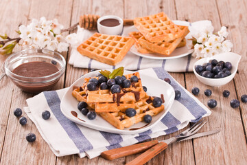 Waffles with blueberries and chocolate cream. 