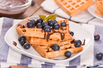 Waffles with blueberries and chocolate cream. 