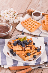 Waffles with blueberries and chocolate cream. 