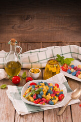 Colored gnocchi with vegetables and sweet corn.