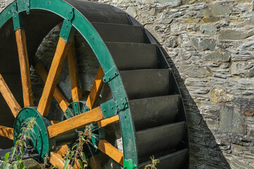 Green wooden and metal water wheel at the Mill on the Fleet at Gatehouse