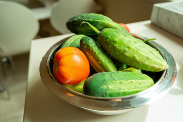 Fresh tomatoes and cucumbers in a bowl