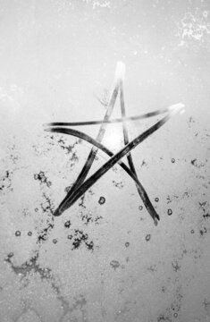 star shine, winter frost, the inscription on the sweaty glass star and sun, black and white photography