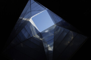 Low angle shot of a modern building against a clear blue sky