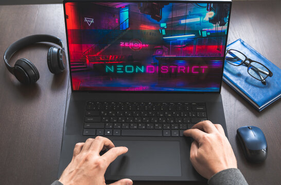 Russia Moscow 30.05.2021.Logo, screenshot of blockchain nft ethereum cryptocurrency kiber punk game Neon District in laptop screen. Man playing,collecting cards. Earning tokens, digital money at home