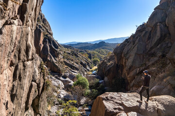 man standing breathing in the fresh mountain air