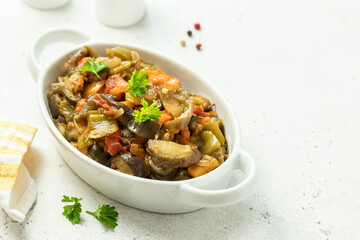 Eggplant zucchini saute in baking dish. Space for text.