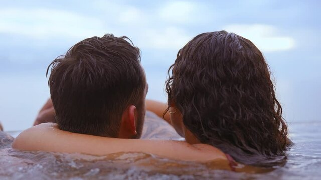 Intimate Shot of a Couple Cuddling While Bathing in an Infinity Pool