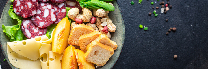 snack plate sausage, meat, cheese, nuts, peach, fruit, toast bread smoked or dry-cured meal snack on the table copy space food background rustic. top view