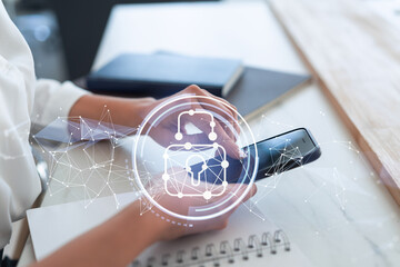A woman programmer is browsing the Internet in smart phone to protect a cyber security from hacker attacks and save clients confidential data. Padlock Hologram icons over the typing hands. Formal wear