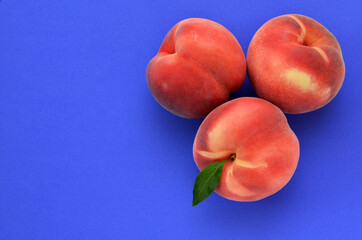 ripe peaches on a blue background and place for text