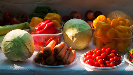 A selection of fruits and vegetables on an open market.