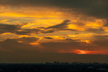Sky beautiful hot summer background. Detailed clouds at sunrise. Sunny yellow and white sky and beautiful fluffy puffy cloudscape Clean of bugs, and dust.