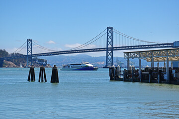 San Francisco waterfront pier with Bay Bridge seen in background