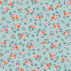 Vintage seamless floral pattern. Liberty style background of small orange coral flowers. Small blooming flowers scattered over a blue background. Stock vector for printing on surfaces and web design.