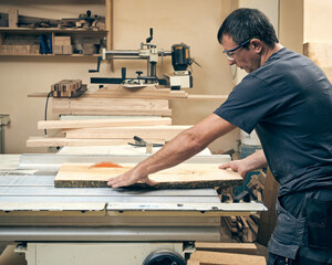 A carpenter is working on a circular saw.