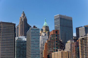 Fototapeta na wymiar Lower Manhattan skyscraper stands under the blue sky on June 18, 2021 in New York City, USA.