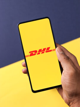 Assam, india - April 19, 2021 : DHL logo on phone screen stock image.