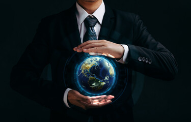 The globe Earth in the hand of businessman with the blurred evening cityscape. Elements of this image furnished by NASA
