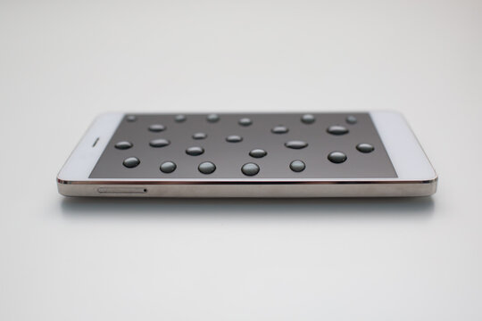 Mobile phone with drops on oleophobic screen