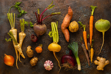 Fresh root vegetables on textured background. Autumn harvest. Concept healthy food.