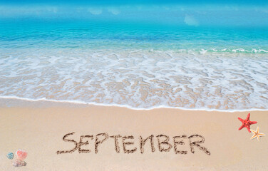 September written on a tropical beach