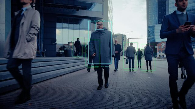 Crowd of Business People Tracked with Technology Walking on Busy Urban City Streets. CCTV AI Facial Recognition Big Data Analysis Interface Scanning, Showing Animated Information.