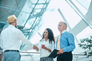 businesswoman meeting her business colleague with a handshake.