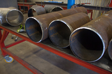 billets of pipes on a steel table with a level